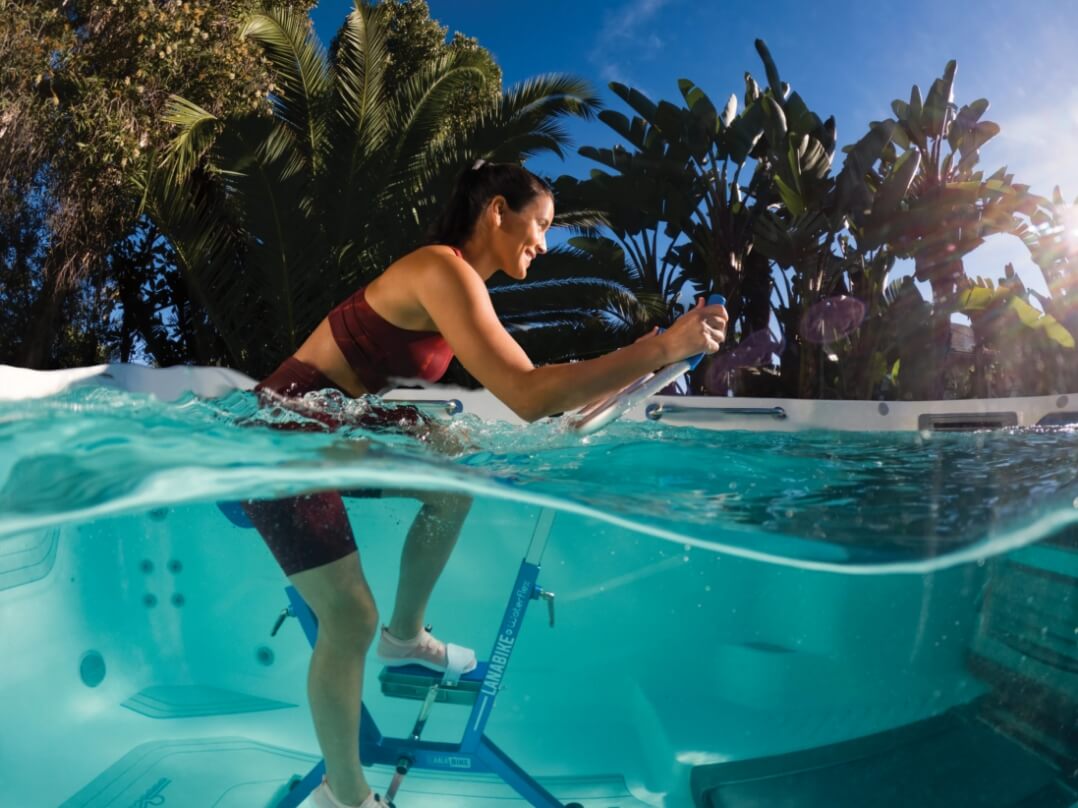 EP_FitnessSystems_2023_E550_AlpineWhite_Lifestyle_Woman_Aquabike_Split_Side_001_pop